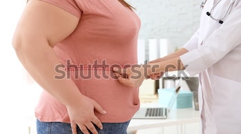 female-doctor-measuring-waist-overweight-600w-1115769623-2-2